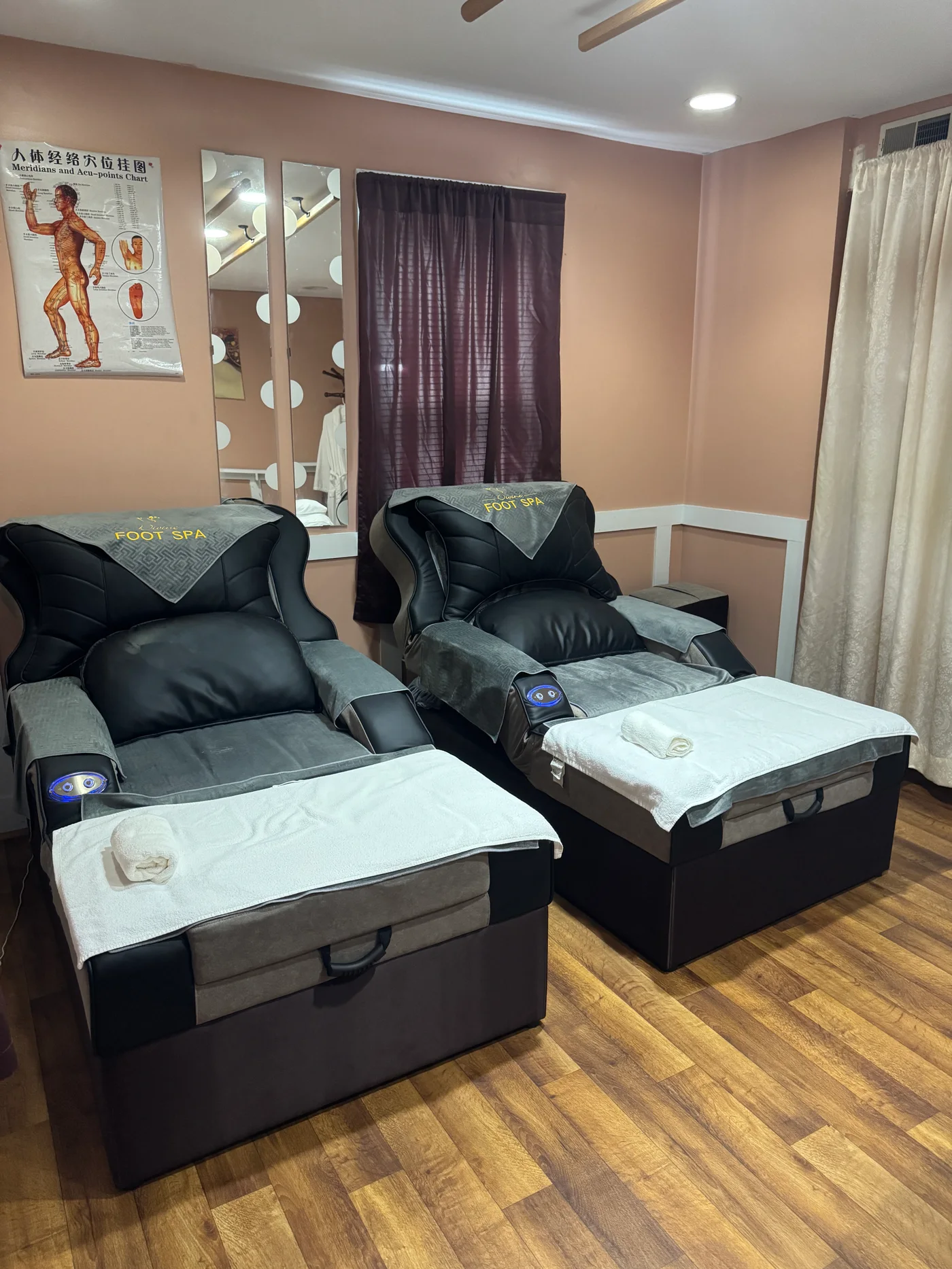 Two reclining foot massage chairs with white towels at Wellness Foot Spa in Glenside, PA
