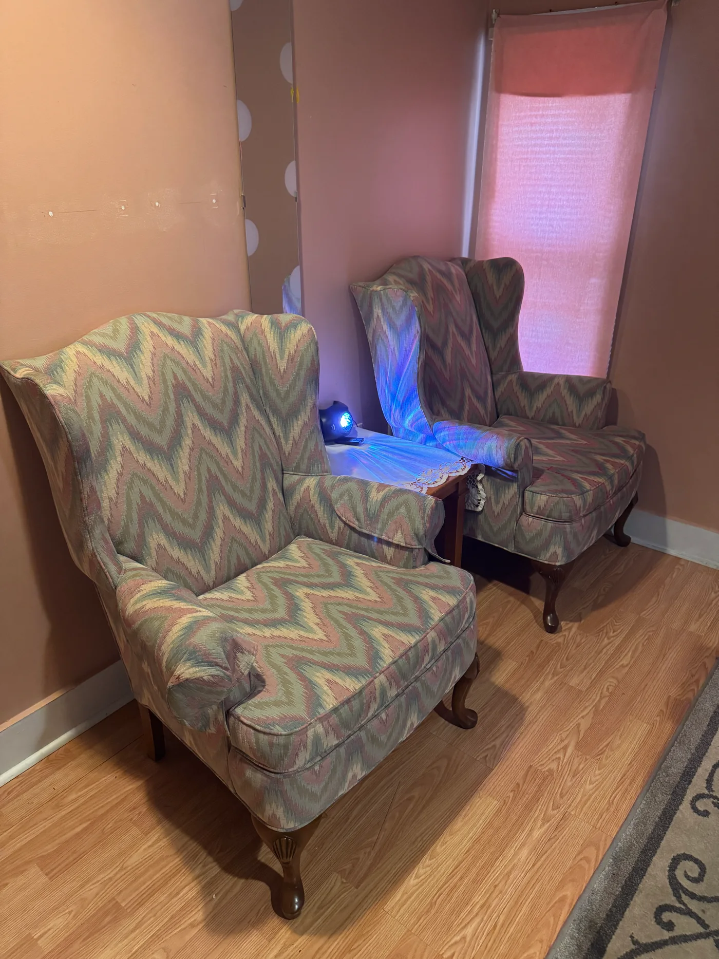 Two patterned armchairs beside a pink curtain at Wellness Foot Spa in Glenside, PA